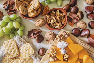 Table with a variation of autumn fruits. Background with fruit, nuts and pumpkin. All Saints Day.