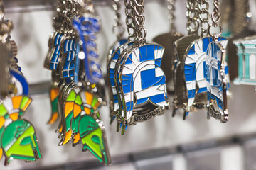 View of traditional tourist souvenirs and gifts from Athens, Attica, Greece with fridge magnets with text "Greece", "Athens" and key ring keychain, in local vendor souvenir shop in Monastiraki