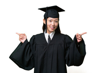 Young university graduate Asian woman over isolated background pointing finger to the laterals and happy