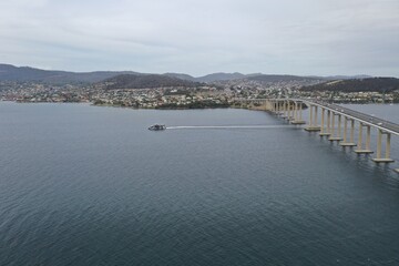 A boat crossing under the bridge