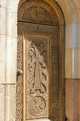 Fototapeta na wymiar Armenia, Noravank, September 2022. Carved wooden door of an old temple.