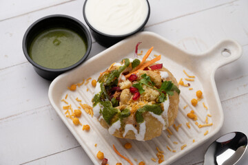 Rajasthani Shahi Raj-Kachori, stuffed with potato and sprout filling. served with curd, chutney and sev in a plate © Ojas