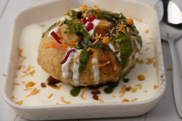 Rajasthani Shahi Raj-Kachori, stuffed with potato and sprout filling. served with curd, chutney and sev in a plate