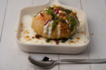 Rajasthani Shahi Raj-Kachori, stuffed with potato and sprout filling. served with curd, chutney and sev in a plate