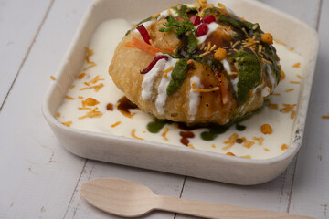 Rajasthani Shahi Raj-Kachori, stuffed with potato and sprout filling. served with curd, chutney and sev in a plate
