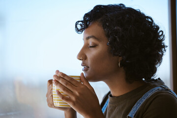 Indian woman drinking coffee, tea and happy peace, mindset and relaxing at home window. Face of hipster young gen z girl sipping hot beverage mug for calm day, lifestyle and break alone in apartment