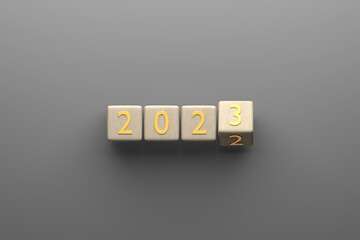 Wooden cube turns from 2022 to 2023 on gray background. 3D Illustration. Top view. New year concept.