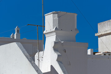 Traditional chimney on the roof of a houses in Olhao, Faro district, Algarve, Portugal