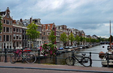 Fototapeta premium Bikes on a bridge over the canal in Amsterdam