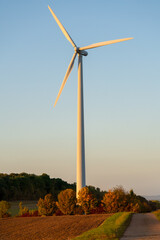 Fototapeta na wymiar Wind Turbine against clear blue sky on a sunny evening