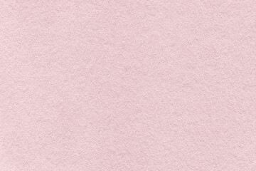 Texture of vintage light pink colors paper background, macro. Structure of dense rose gold craft cardboard.