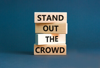 Stand out the crowd symbol. Concept words Stand out the crowd on wooden blocks on beautiful grey table grey background. Business, stand out the crowd concept