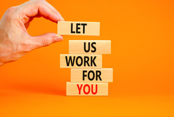 Let us work for you symbol. Concept words Let us work for you on wooden blocks. Businessman hand. Beautiful orange table orange background. Business and let us work for you concept. Copy space.
