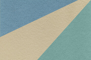 Fototapeta na wymiar Texture of old craft beige, blue and denim color paper background, macro. Vintage abstract cerulean cardboard.