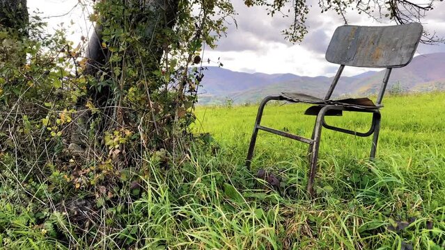 An abandoned chair in a field