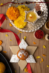 Raksha bandhan greetings : Sweet food like kajurolls, pista laddoo, Bundi Laddu, Kaju Katli and farsan with Pooja thali for Rakhi Festival Celebration 