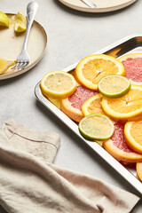 Top view of sliced ​​citrus on a tray. Orange, grapefruit, lemon and lime showcasing healthy food in a flat lay. Natural beauty, medical concept of cliced fruits.