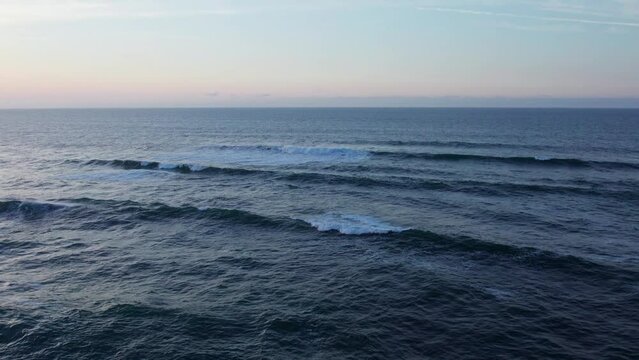 Orbit Drone Footage Of The Blue Clear Sea Ocean Water With Small Waves, Comillas Coast, Spain
