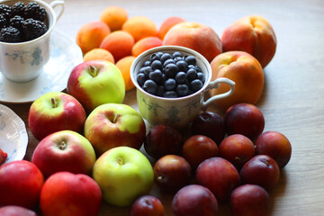 Various healthy seasonal food arranged on wooden background. Selective focus.