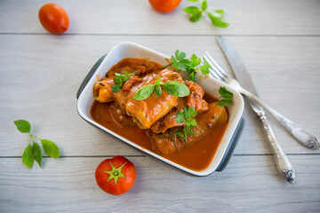 Traditional stuffed cabbage with minced meat and rice, served in a tomato sauce.