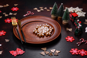 Christmas decoration elements as well as gingerbread on a brown concrete background
