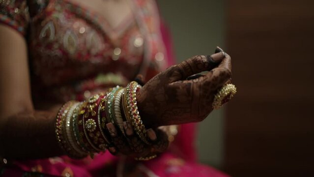Indian bride wearing beautiful bangles in hand for wedding ceremony