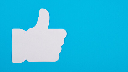 White thumb up on blue background, like symbol.