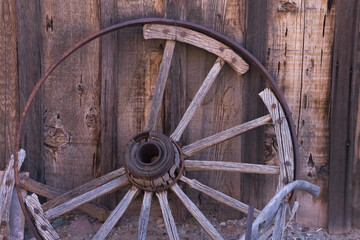 Old wooden wagon wheel with a metal hub