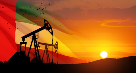 Fototapeta premium The change in oil prices caused by the war. Oil prices are rising because of the global crisis. Oil drilling derricks at desert oilfield with UAE flag. Crude oil production from the ground.