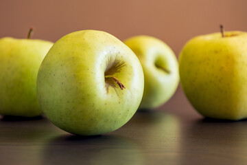 bunch of green apples at the kitchen table close up