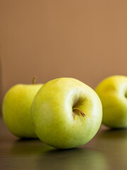 bunch of green apples at the kitchen table close up