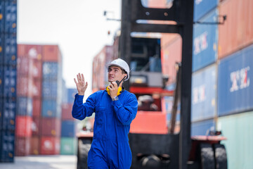 Foreman control forklift unloading truck at the container yard warehouse.
