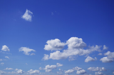 The blue sky with fluffy clouds in summertime