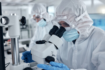 PPE, covid and DNA scientist with microscope research for science innovation, investigation and...