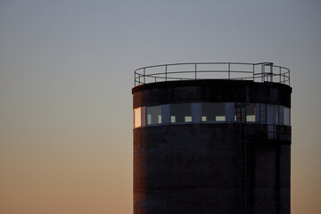 close up of cylinder building with sunset