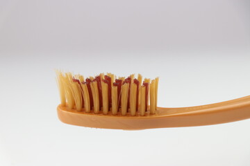 Used toothbrush with a view of its bristles that is an essential object for every individual to keep the good oral hygiene