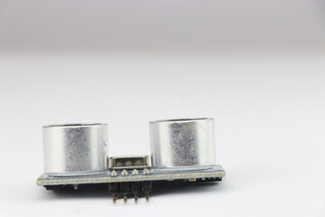 Ultrasonic distance sensor with view of its transmitter and receiving part laid on a white background