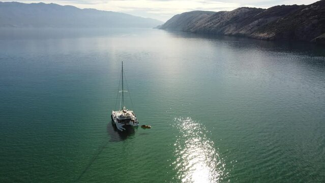 catamaran, sailboat, anchored in shallow sea, Adriatic Sea, Croatia, summer, late morning, sunny