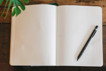 Notebook and pencil on wooden table