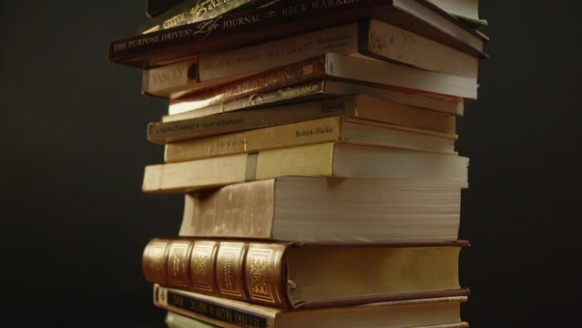 Pile of books spinning while the camera is tilting up