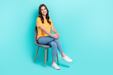 Full length photo of sweet pretty girl dressed yellow t-shirt smiling sitting chair empty space...