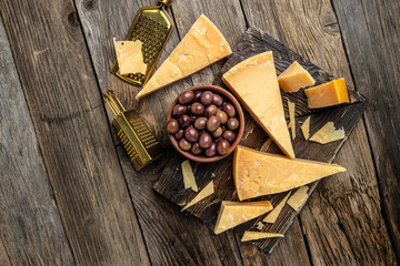 Parmesan, Hard cheese, olives, rosemary on a wooden board, Restaurant menu, dieting, cookbook...