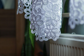 Close up of curtain part. curtain in window frame, interior detail. Beautiful transparent white curtains in an apartment