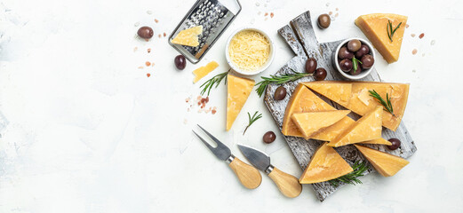 Parmesan, Hard cheese, olives, rosemary on a wooden board, Long banner format. top view