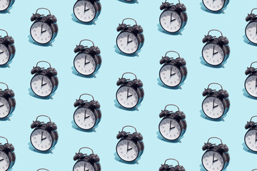 Seamless pattern of black retro alarm clocks  show 2 o'clock. Changing clock from summer time to...