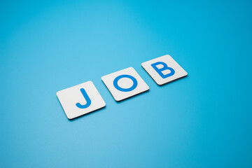 Word JOB on blue background,obtain employment concept.