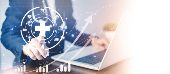 Healthcare and medical concept. Doctor touch the Red cross hologram. Doctor working in laboratory room with notebook (Laptop). Research and development for Medical technology.