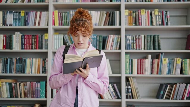 Readhead student flips pages of book looking for information