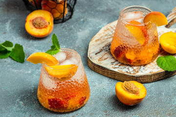 drinks peach, homemade peach cocktail with ice cubes, and mint in glass. Refreshing summer homemade non-alcoholic cocktails, Long banner format