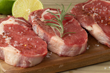 Raw meat steak with seasonings.